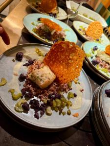 a plate of food on a table with plates of food at LE DOMAINE DE COAT ROGAN, La chambre du Jaudy in Pommerit-Jaudy