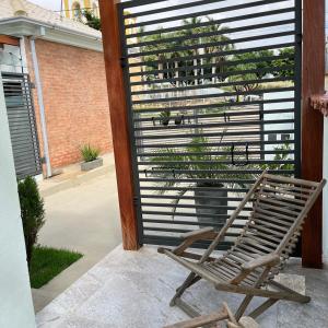 a chair sitting on a patio with a plant at Casa BLUE Praça 102 in Carrancas