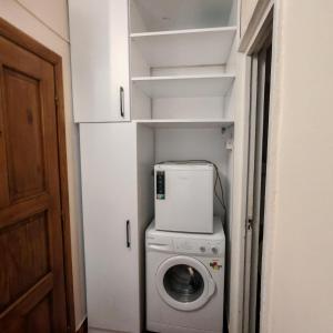 a washer and dryer in a small room at Magic Apartments 2 in Miercurea-Ciuc