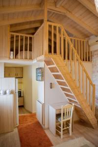 a loft bed in a tiny house at Μικρό σαλέ. in Pournára +27 photos