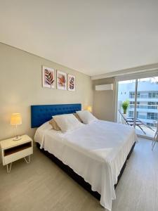 a bedroom with a large white bed and a balcony at Luxury Ocean View Aparment in Cartagena de Indias