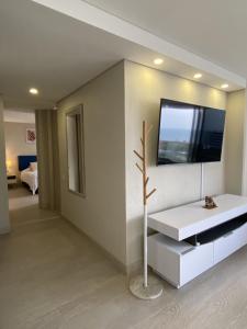 a living room with a television on a wall at Luxury Ocean View Aparment in Cartagena de Indias