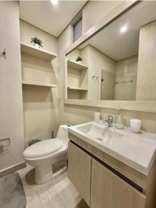 a bathroom with a sink and a toilet and a mirror at Luxury Ocean View Aparment in Cartagena de Indias +29 photos