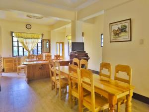a dining room with a wooden table and chairs at Sagada Staycation with Mountain View - 1st Floor in Sagada
