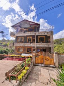 a house with a gate in front of it at Sagada Staycation with Mountain View - 1st Floor in Sagada