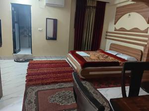 a bedroom with two beds and a rug at Hotel ratna priya pvt ltd in Biratnagar +1 photo