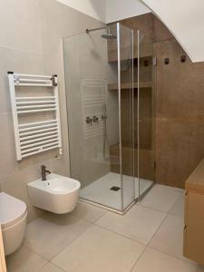 a bathroom with a shower and a toilet and a sink at Virgin Mare in Giovinazzo +25 photos