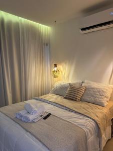 a bedroom with a large bed with towels on it at Casa Vista Mar - Praia do Frances in Marechal Deodoro