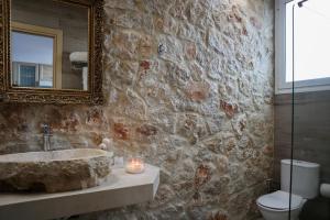a bathroom with a sink and a mirror and a toilet at Seascape Apartment with Private Balcony in Faliraki in Faliraki