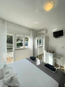 a bedroom with a large bed with two pillows on it at Apartman & rooms Draga in Marina