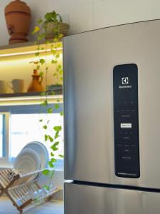 a refrigerator with a remote control on the side of it at Casa Vista Mar - Praia do Frances in Marechal Deodoro +17 photos