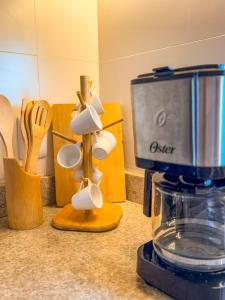 a kitchen counter with a food processor and utensils at Casa Vista Mar - Praia do Frances in Marechal Deodoro