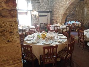 a dining room with tables and chairs in a building at Casa porta San Francesco in Alatri