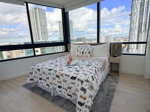 a bedroom with a bed with a view of a city at District 225 in Miami +19 photos
