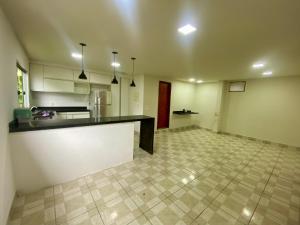a large kitchen with a counter in a room at Casa Centro do Rio in Rio de Janeiro