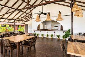 a dining room with wooden tables and chairs at Redang Divers Resort in Redang Island