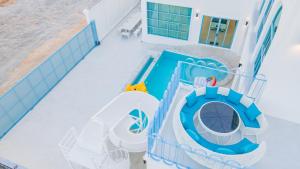 an overhead view of a water slide and a pool at Blue Tierra Pool Villa Pattaya in Ban Hua Phrong