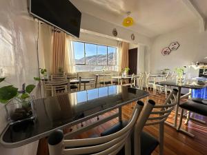 a dining room with tables and chairs and a large window at Skyline in La Paz