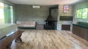 a living room with a woodburning stove in a room at Recanto Colina in Picada Cafe