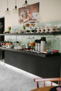 a kitchen with a counter with food on it at POUSADA ACONCHEGO MT in Chapada dos Guimarães