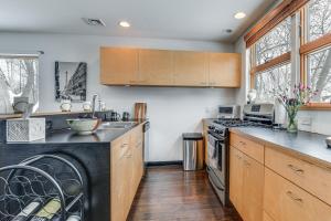 a kitchen with a sink and a stove top oven at Couple’s Retreat Near UVM! Unique Studio w/ Deck in Burlington