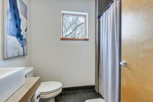 a bathroom with a toilet and a shower at Couple’s Retreat Near UVM! Unique Studio w/ Deck in Burlington +16 photos