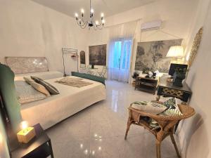 a bedroom with a bed and a living room at La suite a pochi passi dal mare in Trapani