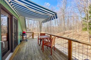 a deck with a table and chairs on it at Half-Mile to Crystal Lake! Couples Retreat w/ Deck in Beulah