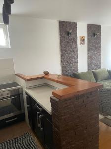 a kitchen with a counter top and a living room at Prvi maj in Ub +1 photo
