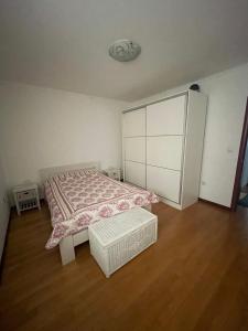 a bedroom with a bed and a white cabinet at Prvi maj in Ub