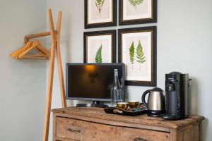a tv sitting on top of a wooden table at The Bottle & Glass Inn - Garden View - Room 1 in Henley on Thames