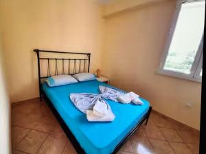 a blue bed with towels on it in a room at Sea View in Dhermi in Gjilek