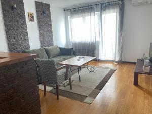 a living room with a couch and a table at Prvi maj in Ub