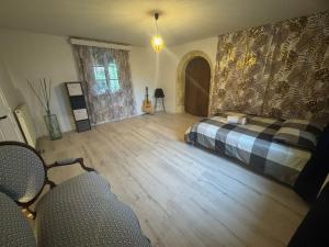 a bedroom with a bed and a wooden floor at Lorette in Le Veurdre +25 photos