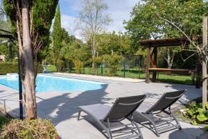a couple of chairs next to a swimming pool at Lorette in Le Veurdre