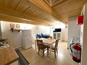 a kitchen and dining room with a table and chairs at Perla 19 - UN LETTO IDEALE in Gaeta