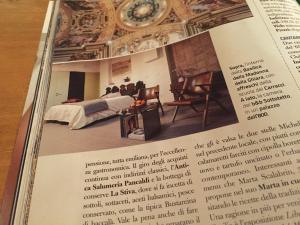 a page of a magazine with a bedroom in a room at B&B Sottotetto in Reggio Emilia
