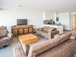 a living room with a couch and a coffee table at Les Amiraux - 0701 + box 2 in Westende-Bad +6 photos