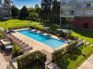 an overhead view of a pool with chairs and umbrellas at iDeal Concord Pilar Aparts in Pilar