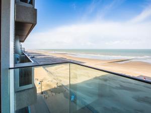 a view of the beach from the balcony of a building at Les Amiraux - 0701 + box 2 in Westende-Bad