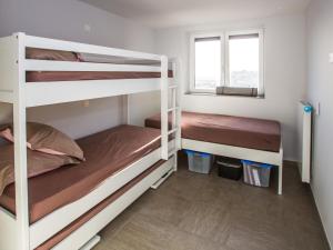 a bedroom with two bunk beds and a window at Les Amiraux - 0701 + box 2 in Westende-Bad