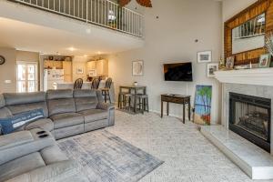a living room with a couch and a fireplace at Pool & Beach Access: Lake of the Ozarks Condo in Osage Beach