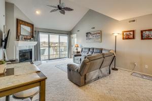 a living room with a couch and a fireplace at Pool & Beach Access: Lake of the Ozarks Condo in Osage Beach