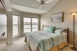 a bedroom with a bed with a ceiling fan and windows at Pool & Beach Access: Lake of the Ozarks Condo in Osage Beach +22 photos