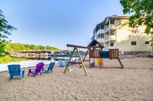 a playground with chairs and a slide on the beach at Pool & Beach Access: Lake of the Ozarks Condo in Osage Beach