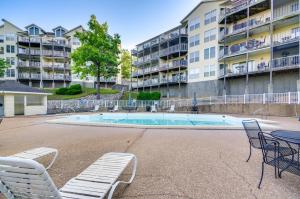 a pool with chairs and a table and a building at Pool & Beach Access: Lake of the Ozarks Condo in Osage Beach
