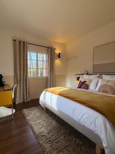 a bedroom with a large bed and a window at Maison d'Hôtes HAITZ TEYA - La Chênaie in Ascain +26 photos