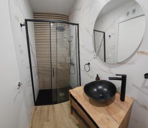 a bathroom with a black sink and a shower at HOSTAL ANDREA GRANVIA in Madrid +43 photos
