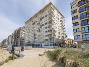 a large building on the beach next to the sand at Trianon - 0609 in Westende-Bad