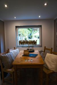 a room with a wooden table with chairs and a window at Landhaus Sonnenwinkel in Brodenbach